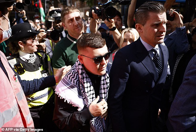 BBC must not show Kneecap at Glastonbury says Kemi Badenoch after member of Irish rap group was charged with carrying Hezbollah flag